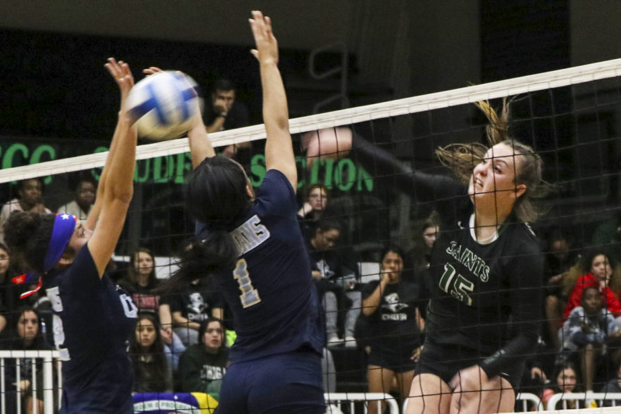 Thais Vieira slams the ball down for two points, helping the Lady Saints win the Region VI Championship. The sophomore middle blocker from Brazil is on her second Regional championship team.