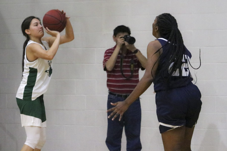 Gina Ballesteros shoots from the corner during a Lady Saints scrimmage. The freshman guard from Ulyssess is one of the few local Kansas athletes playing at SCCC.