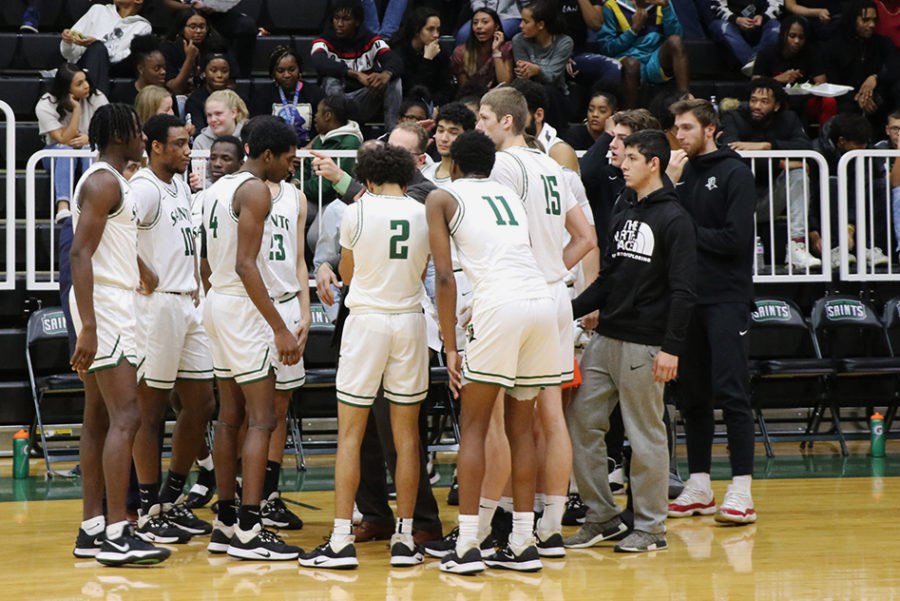 Saints huddled together during a time out. Three players sat out the game due to injuries. The loss of substitutes had a big affect on the game. The Saints lost 78-75.