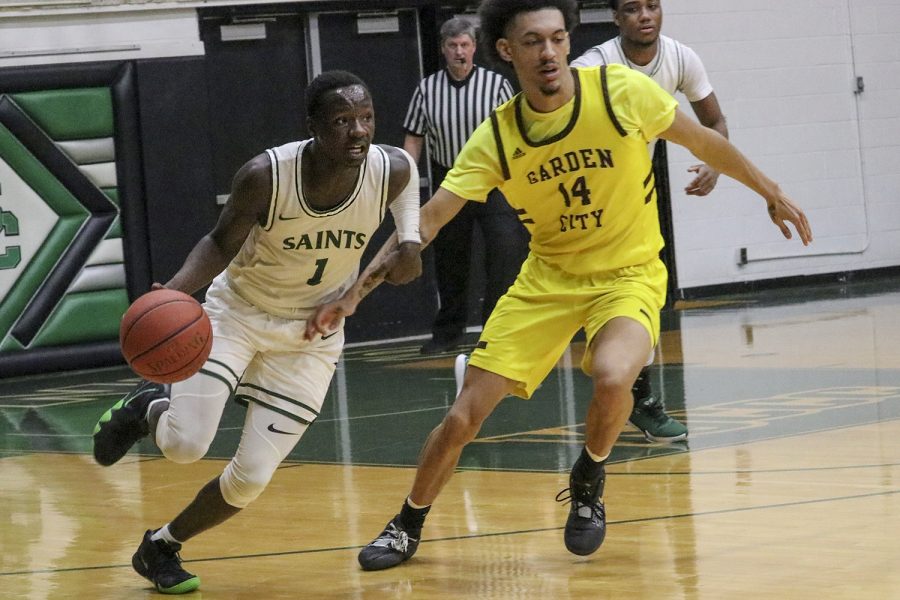 Branton McCrary dribbles past Garden City Community Colleges Steven Samuels. The freshman guard from Little Rock, Arkansas broke Garden Citys press wide open with the dribble move. The Saints won the game 78-73.