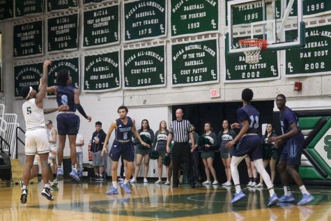Greg Johnson shooting at the free throw line. The freshman guard is from Little Rock, Arkansas and he made four points against Colby Community College.