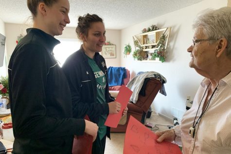 Basketball players Karolina Szydłowska and Wiktoria Kazimierowicz hand out a Valentine to a Brookdale resident. This is the second time the library has sponsored this event.