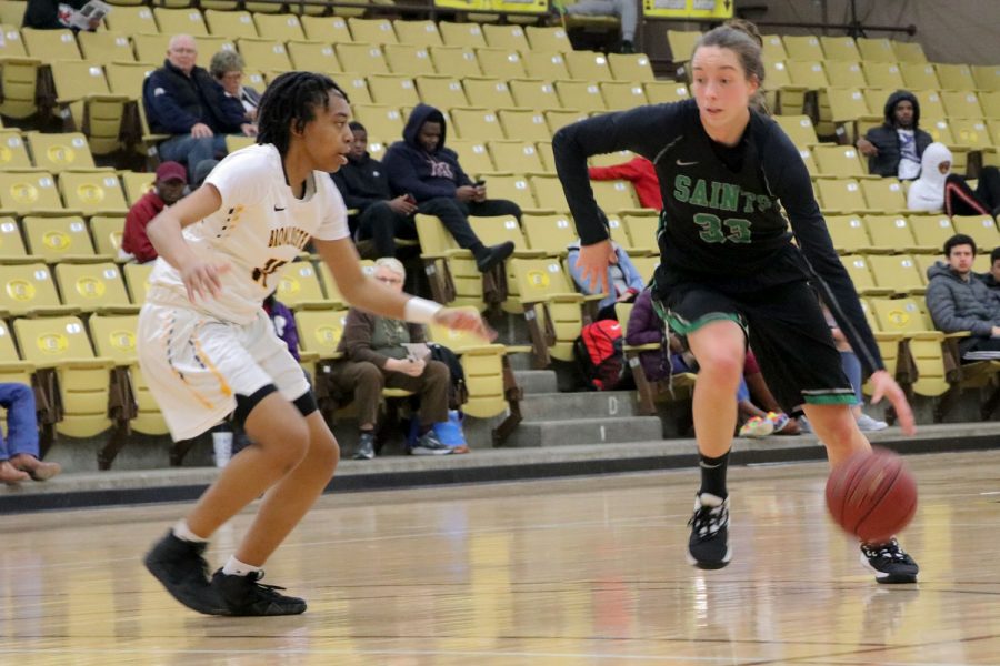 Karolina Szydlowska runs to the basket. She made 18 points last night against Garden City Community College. She plays forward for the Lady Saints and comes from Wroclaw, Poland.