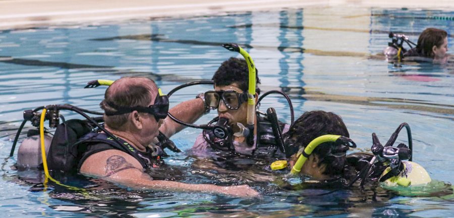Instructor Mike Hale is showing high school students what to do when his oxygen tank runs out of oxygen. As students are practicing underwater, Hale turns off a student’s tank to give a step-by-step safety process. 
