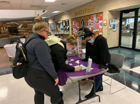 Mack and Sydney Grant, siblings from Liberal, stop by the Domestic Violence table to talk to Maria Munoz, campus advocate/ intake specialist. The student activity fair was Sept. 9-10 and was moved inside due to the weather.