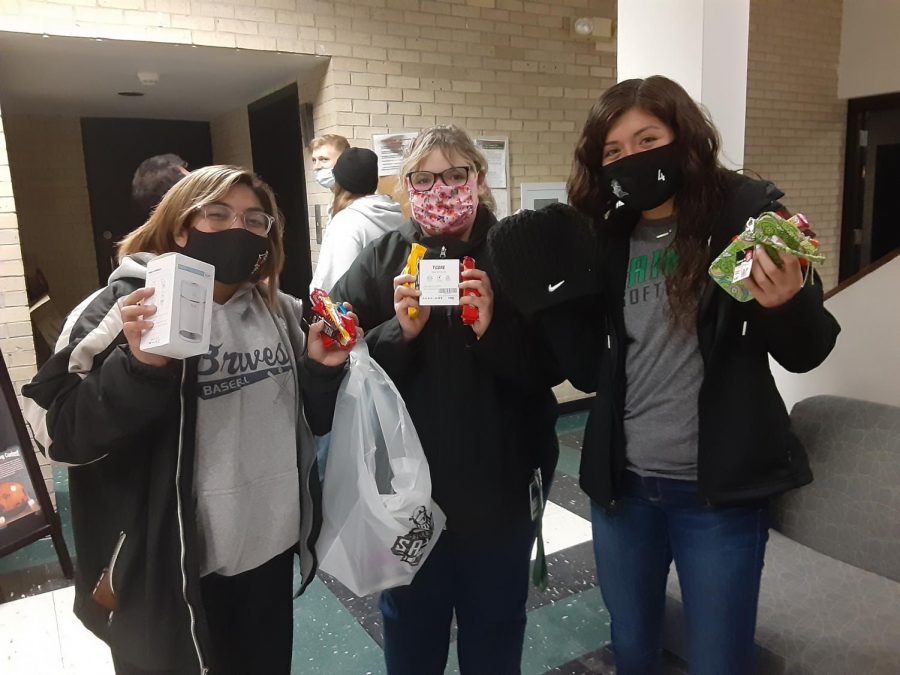 Alondra Galindo, a sophomore majoring in biology, Esi Houtz,  a sophomore Nursing Major, A.J. Luna, sophomore ASL Major show off the prizes that they won from the nightime egg hunt. The egg hunt had been scheduled for Easter earlier this year but unfortunately COVID shut down campus and the event was not able to take place until this fall  
