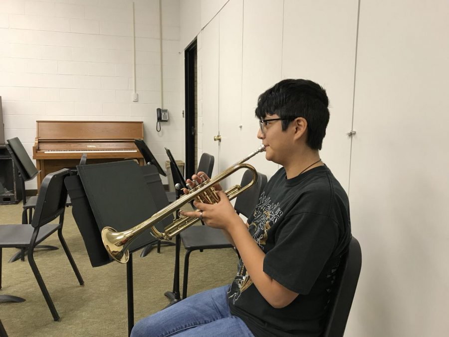 Allegra Tomores,  who is music major shows off her musical talent by practicing her trumpet in one of the music room in the Humanities building. 