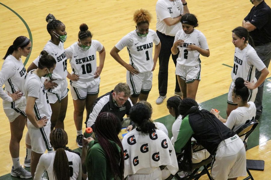 The Lady Saints huddled together and got plans for the next play that they could execute after the timeout had ended. (file photo)
