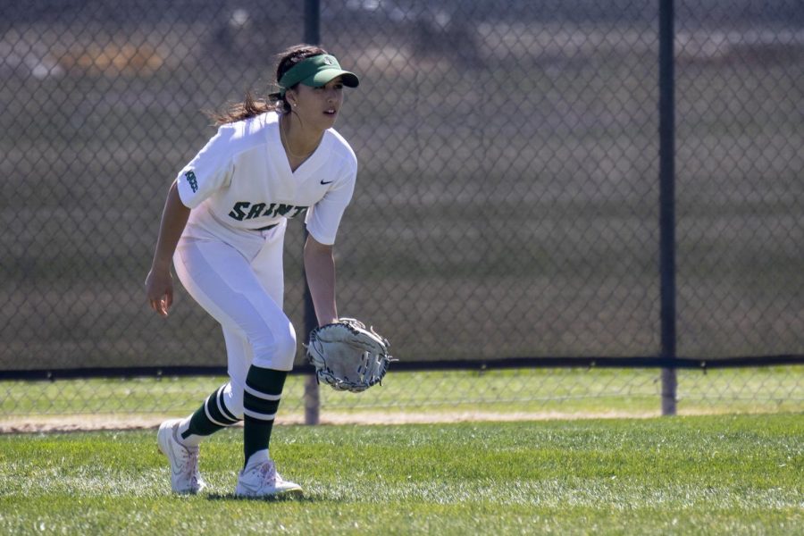 Lady Saints Center fielder, Ashley Low gets down and ready to field the upcoming ball.  Low came out with  3 RBI's,  one run and one home run. 