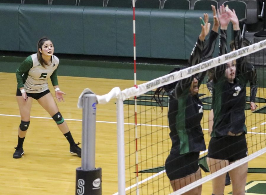 Grecia Soriano, libero from Lima, Peru, protects the court under the double block at the net. The Lady Saints were down two matches before climbing back, winning three in a row to record the win. (file photo)
