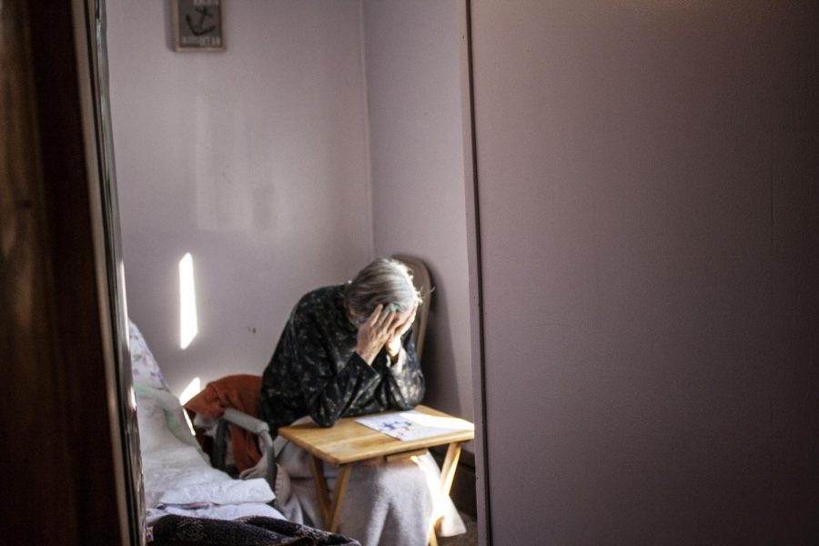 Anne McKeown rests her head in her hands, taking a break. “I see her daily frustration,” says Jean Fields, McKeown’s daughter and caregiver. “I feel like there’s so many thoughts in her head and she just can’t get them out.”