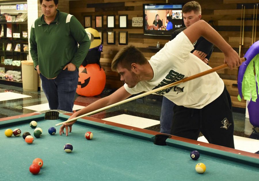 A champion at work, Karlos Krolo, a freshman sports management major, sets up for a  tricky shot. Krolo went on to place first and win the pool tournament hosted by Student Government Association. 