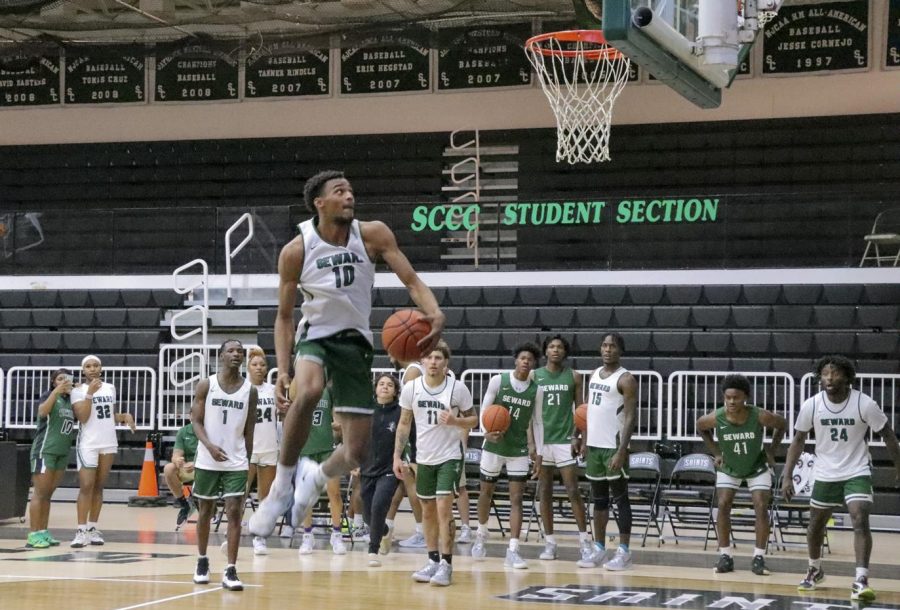 Julian McGowan, guard for the Saints, takes the ball between his legs as part of his trick for the dunk competition on Oct. 28 at the Greenhouse. McGowan is from Trenton, New Jersey. 