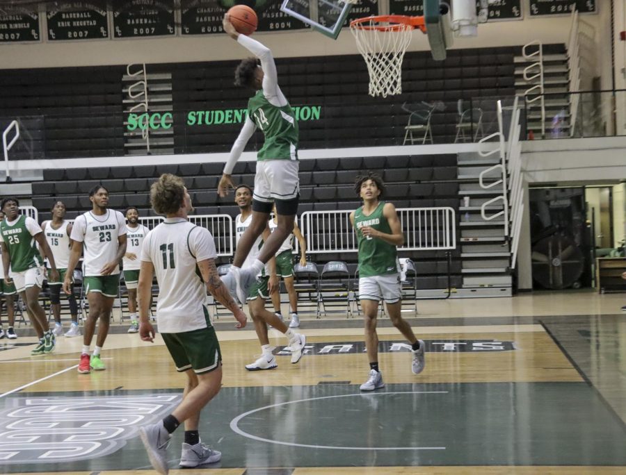 Jaylin Henderson goes up for a dunk during the scrimmage at the Greenhouse. Henderson plays as guard for the Saints, and is from Wichita. 