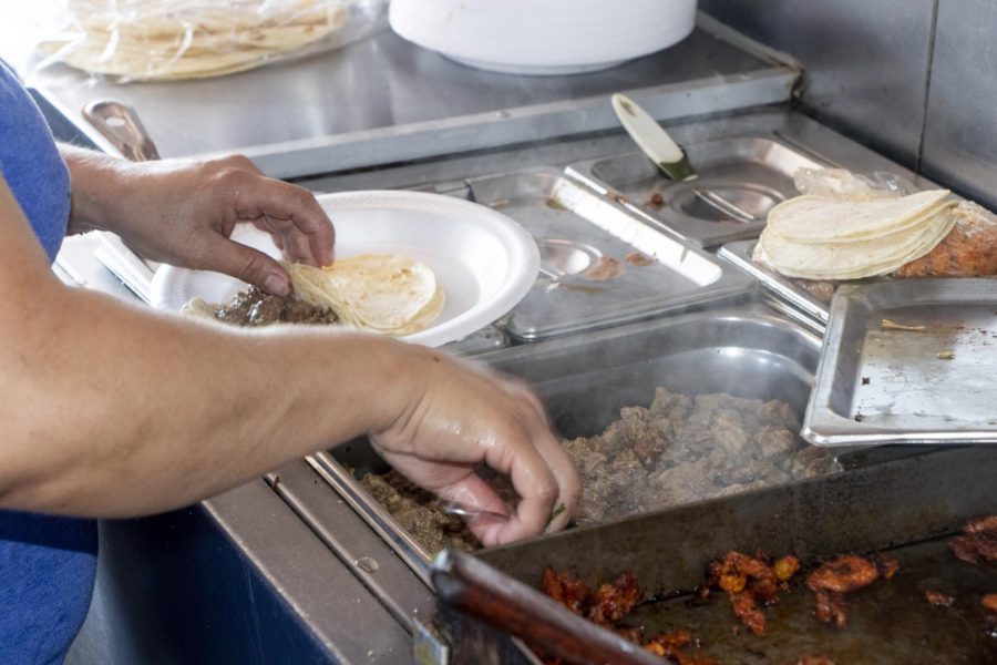 Chilangolandia’s cook fills hot off the grill tortillas with carne asada. These steak tacos are a popular order at the taco truck. 