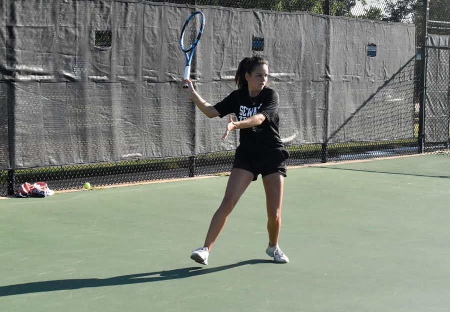 Creating a firm foundation, Justine Lespes gets set for a strong forehand return.