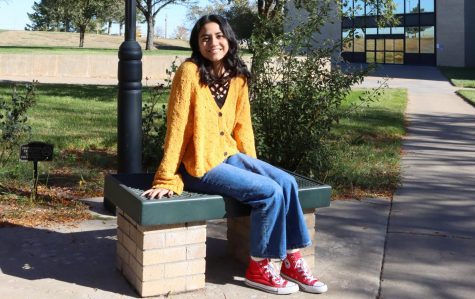 Sweaters and jeans are tops on the list for clothes to have during the fall and winter months. Aidaly Ramos, freshman from Liberal, finishes her outfit with some classic “Chucks.” 