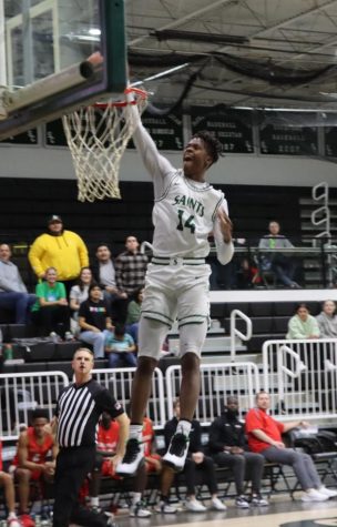 Jaylin Henderson takes control of the court and finishes with a slam dunk. With no one in sight, Henderson uses this opportunity to gain the Saints two more points.