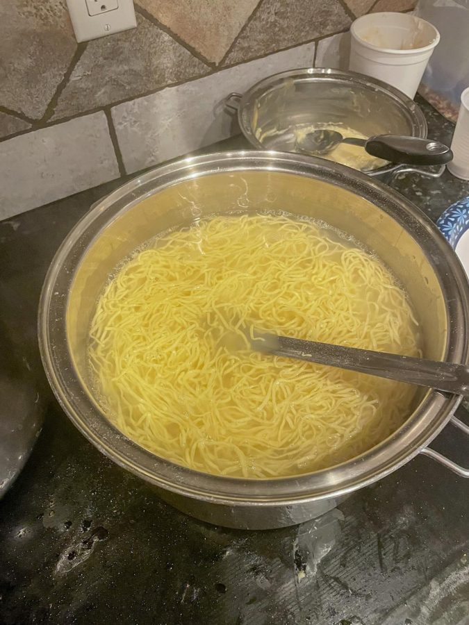 Megan Berg tossed homemade noodles into a boiling pot of water to cook for about twenty minutes. The noodles will be strained and stirred into the chicken broth making the final dish of chicken noodle soup for a family favorite snow deal meal. 