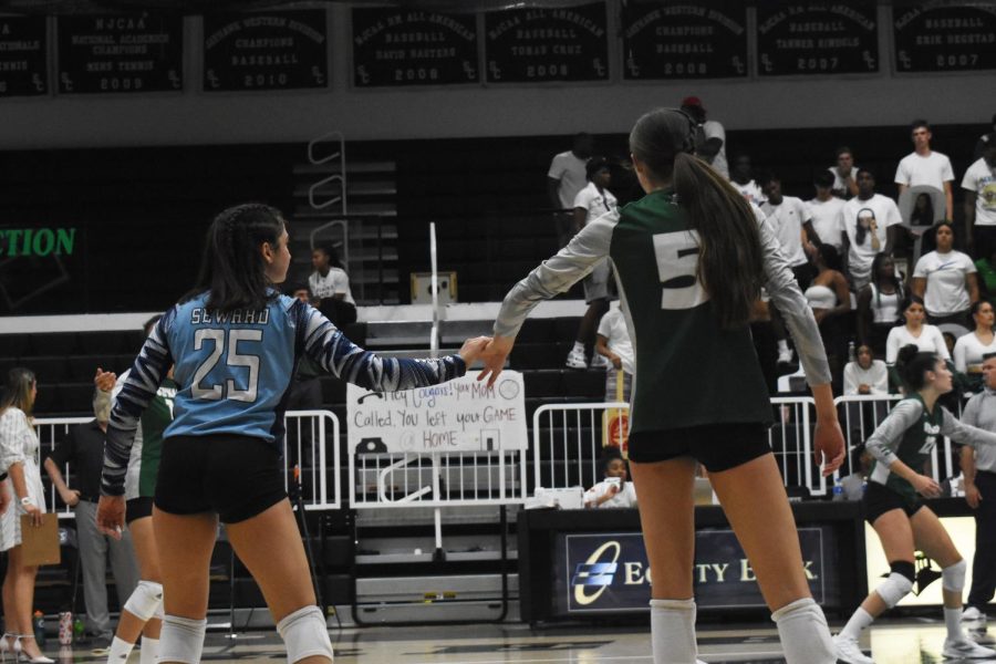 Micell Jerez and Aubreigh Haxton celebrate after a kill for Haxton number 5 on Tuesday night. The Lady Saints went 3-0 with Barton Community College to improve to 3-0 in our conference and 10-2 overall. 