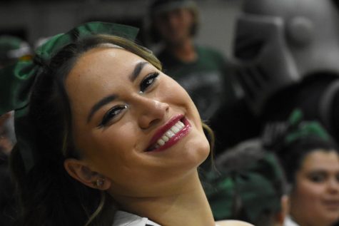 Paulina Reyes-Espinoza sits in the stands of a basketball game in the fall as she cheers for the Saints basketball team to win. Reyes-Espinoza is incredibly involved in Seward County Community College, as she has been a part of TRIO, the cheer team, housing, and a student tutor. 