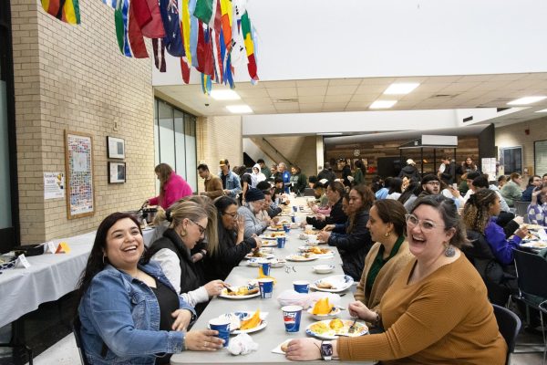 SCCC staff Ruth Rivera and Jamie Francis share a laugh during the event. The occasion featured Mexican cuisine, including ceviche, enchiladas and tamales.