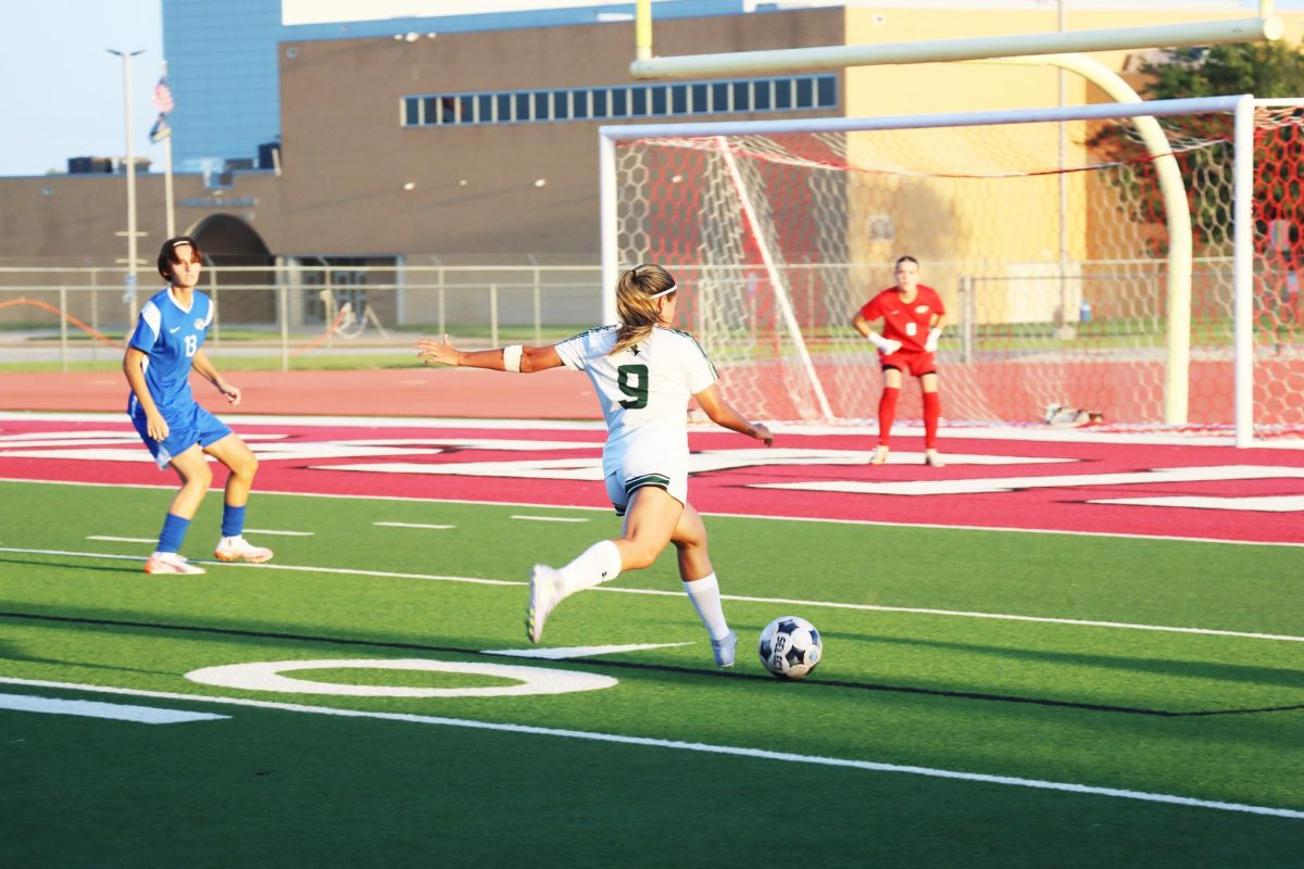 Forward Julia Astrath rushes around with the ball aming to score. Astrath is a freshman from São Paulo, Brazil. 