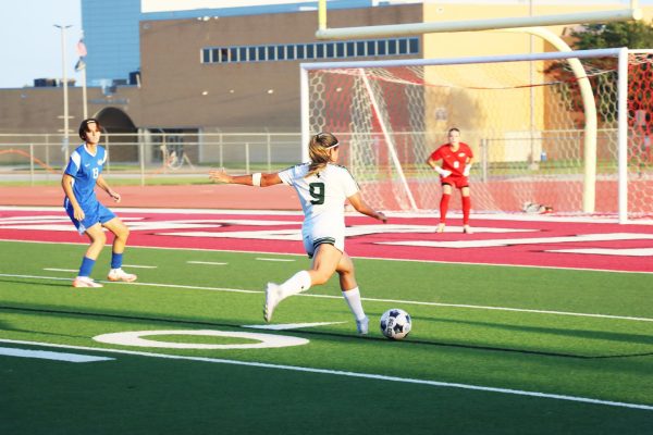 Forward Julia Astrath rushes around with the ball aming to score. Astrath is a freshman from São Paulo, Brazil. 