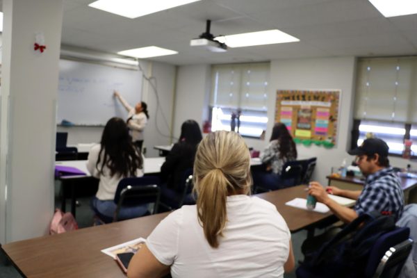 Adult education students sit and listen to Victoria Bangs' math lecture. For the entire class, Bangs taught and spoke entirely in Spanish.
