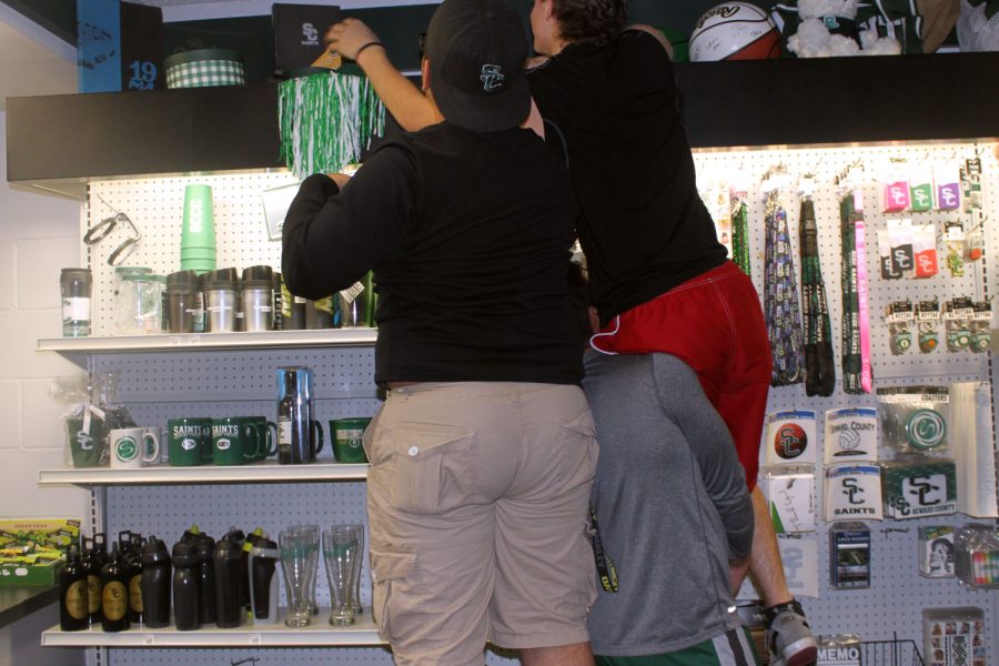 Diego Becerril, Obadiah Barnett, and Emanuel Serrano help each other to search for eggs that were hidden up in the top shelves.