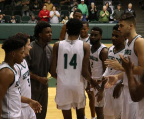 Small high fives his teammates as he gets announced before starting the game against Neosho Community College. Small is usually one of the starters for the Saints.