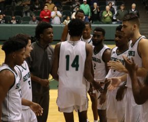 Small high fives his teammates as he gets announced before starting the game against Neosho Community College. Small is usually one of the starters for the Saints.