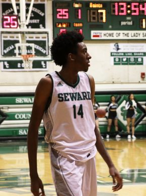 Small walks to other side of the court as his teammate dribbles the ball down to start their play against their opponent in the first half.