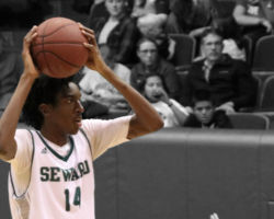 Small protects the ball by putting it above his head and looks for a teammate that is open for a pass.