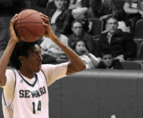 Small protects the ball by putting it above his head and looks for a teammate that is open for a pass.