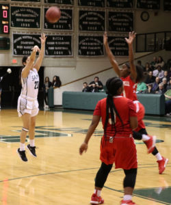 Sophomore, Vanessa Caro, shoots a three-pointer as her opponent attempts to block it. Vanessa was 4 of 5 from behind the arc. She had a career-high of 16 points.