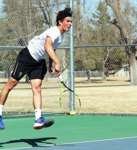 Freshman, Franck Soulerot, serves a ball to his Southeastern Oklahoma opponent. Soulerot won the number six spot with scores of 6-4, 6-1.