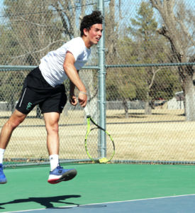 Freshman, Franck Soulerot, serves a ball to his Southeastern Oklahoma opponent. Soulerot won the number six spot with scores of 6-4, 6-1.