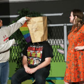 Biviana Rodriguez, playing Lucy Van Pelt, pretends to draw on the face of Charlie Brown, played by Matthew Schmitt. Cast members have spent long hours rehearsing for Friday's opening night.