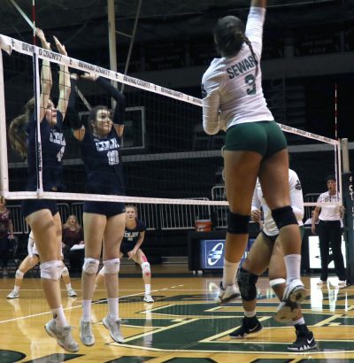 Sophomore Esmadar Tavares hits the ball into a Colby block. Tavares finished the night with 5 kills.
