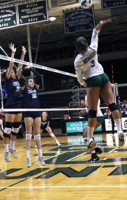 Tavares kills the ball over two Lady Trojans. The Lady Saints defeated the trojans and are now ranked first in the Jayhawk West Conference.