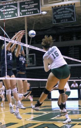 Sophomore right side, Giovanna Tapigliani kills the ball while her defenders try to block. Tapigliani lead the Lady Saints in kills, finishing with 16 total