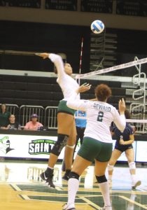 The Lady Saints gained a point as sophomore middle, Luz Sierra kills the ball against the Lady Pirates. Sierra kept her spikes going for the rest of the game.