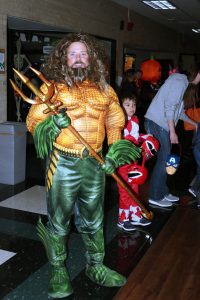 SCCC Biology instructor and Pathway club leader, Don Hayes poses in his Aquaman costume. Instructors, staff members and students in clubs set up booths to give out candy and allow kids to play games throughout the night.