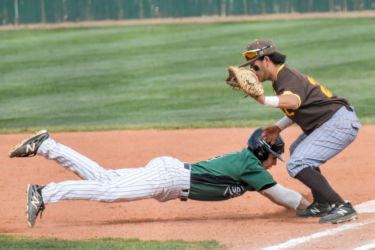 Zane Alexander, Del City, Oklahoma freshman, dives bad to first base. The outfielder is known for his speed and large leads off the bag, driving opposing pitchers crazy. Alexander added two hits towards the end of the game ensuring that Seward takes a doubleheader win.