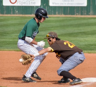 Garden City's first baseman almost tagged Zane Alexander out. The Saints' freshman outfielder stepped on the bag just as the tag came.