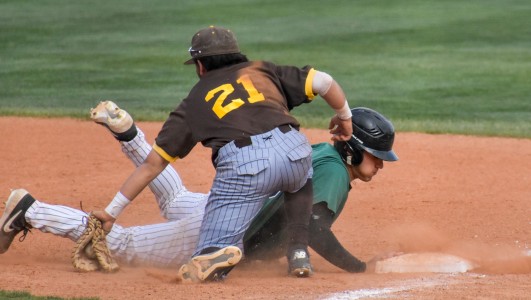 Zane Alexander dives back to the bag from a long lead off. He touched the base just seconds before the Garden City Community College first baseman tagged him. Alexander drove the opposing pitcher crazy on the base path.