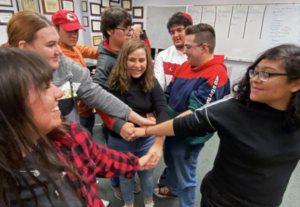 Team building exercise involves trying to untie the human knot. Crusader staff work together to find a solution. It takes teamwork to put out a good news product.