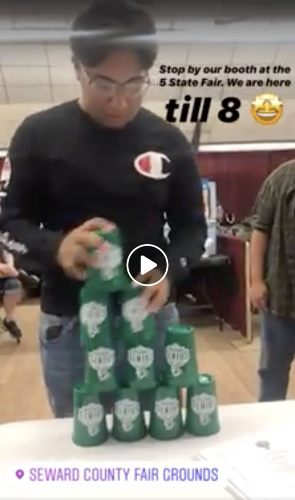 Irvin Gaspar participates in the cup challenge at the SCCC booth during the Five-State Fair. Crusader staff challenged each other and anyone walking past to beat Gaspar, the reigning Cups champion. The game was a way to draw attention to the college booth and keep the staff entertained.