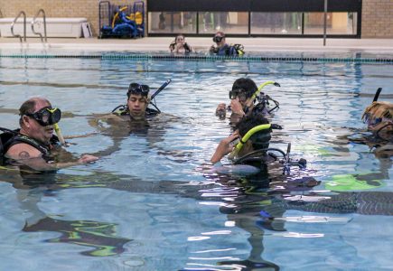 Mike Hale is instructing his class of high schoolers and college students what to do when you have oxygen in their tanks and what steps to take.